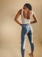 white A SCOOP NECK, AN OPEN BACK AND WIDE TANK STRAPS WITH FITTED BODICE HAVING LACE-UP DETAIL AT THE FRONT. FITTED SILHOUETTE ENDS AT THONG BOTTOMS WITH SNAP CLOSURES.